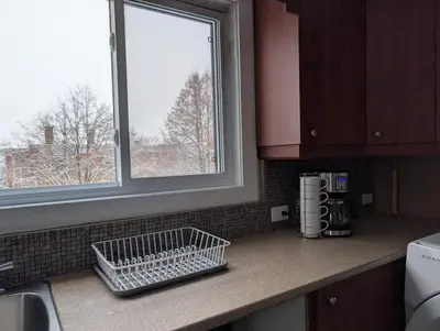 a kitchen counter with a sink and a window at Belle chambre 2 pas Hôpital UQTR Services in Trois-Rivières