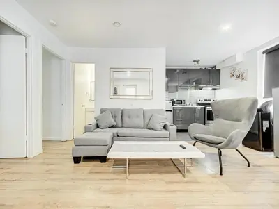 a living room with a couch and two chairs and a table at Appartement central à Montréal - À deux pas de tout in Montréal