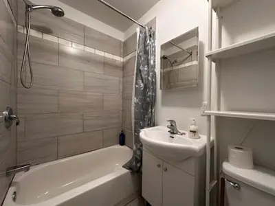 a white bathroom with a sink and a tub and a sink at FULL KITCHEN 10min from DTOWN Room B in Montréal