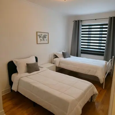 a bedroom with two beds and a window at Appartement cosy, comme à la maison in Montréal