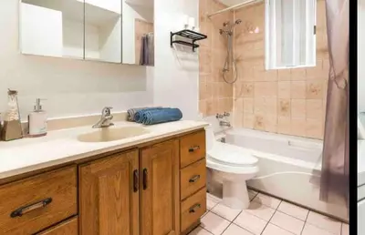 a bathroom with a sink and a toilet and a tub at FULL KITCHEN 14min from DTOWN Room B in Montréal