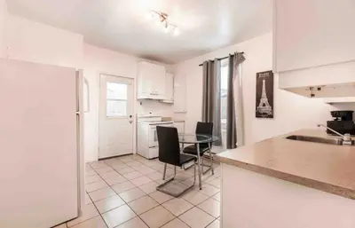 a kitchen with a table and chairs in a room at FULL KITCHEN 14min from DTOWN Room B in Montréal
