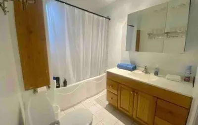 a bathroom with a tub and a sink and a toilet at FULL KITCHEN 14min from DTOWN Room B in Montréal