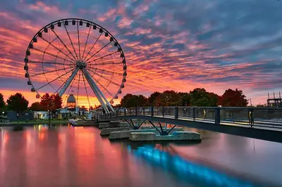 a ferris wheel on a bridge over a river at Montreal's Downtown Glow & Go 2BR Apartment in Montréal
