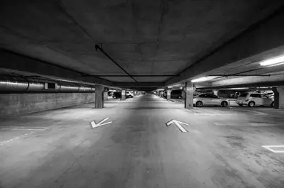 a parking lot with two arrows in a parking garage at Hôtel Saint-Laurent Montréal in Montréal