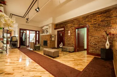 a large living room with a brick wall at Hotel Quartier des Spectacles in Montréal
