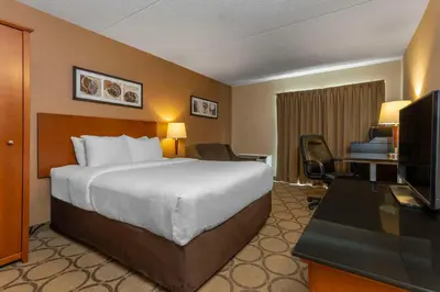 a hotel room with a bed and a television at Comfort Inn Thetford Mines in Thetford Mines