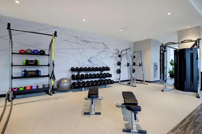 a room with a gym with weights and equipment at Homewood Suites By Hilton Montreal Downtown in Montréal