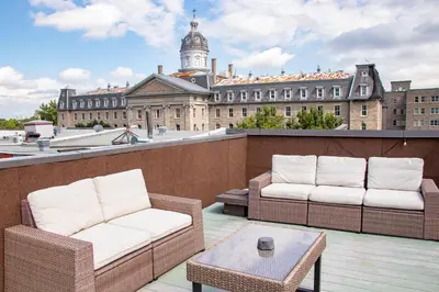 two chairs and a table on a balcony with a building at VINTAGE - SelfCheckIn - Rooftop - Terraces - St-Denis in Montréal