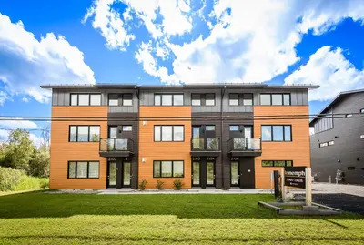 an exterior view of a building at Le Memph Aigle spacious comfortable condo cottage eco friendly 3 bedrooms - hot tub & pool Memphrémagog Lake in Magog-Orford