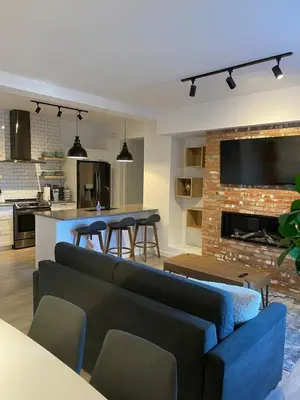a living room with a couch and a fireplace at Bromont Lodge 871 Shefford suite 205 in Bromont
